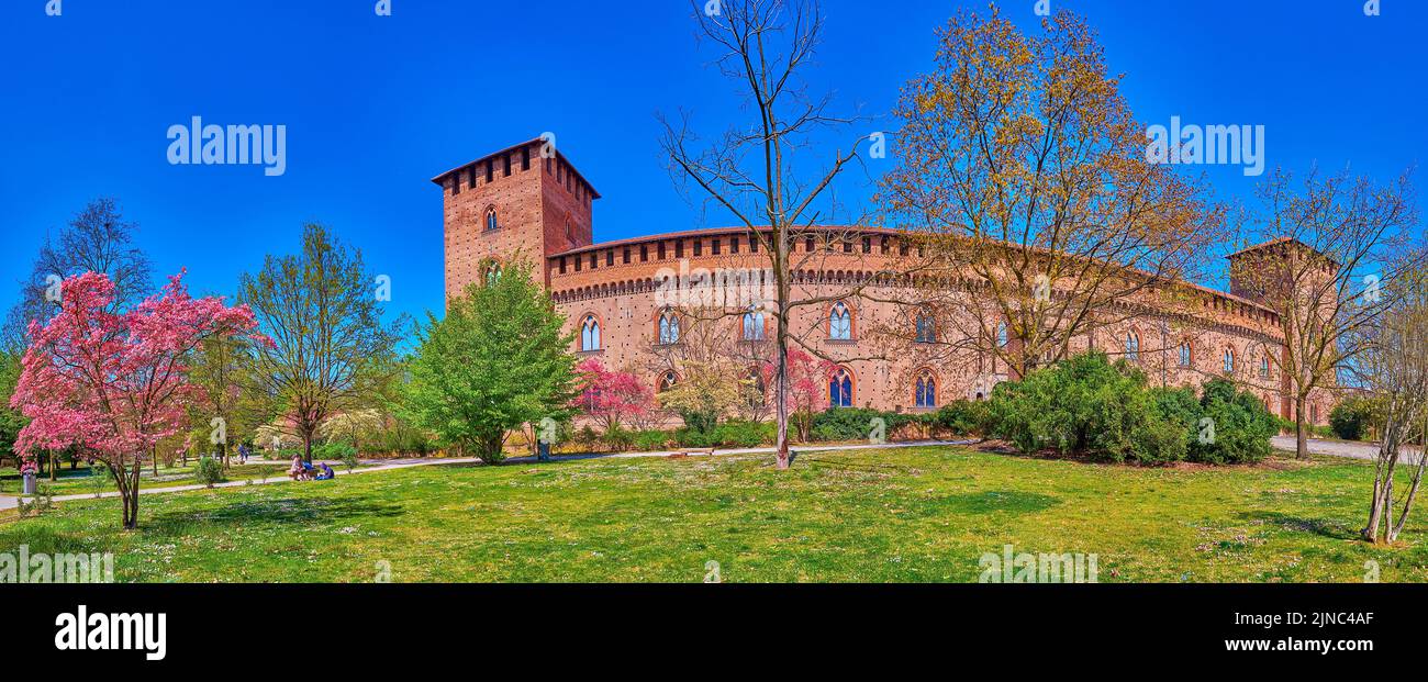 Panorama of Visconti Castle and large park with blooming trees, Pavia, Italy Stock Photo