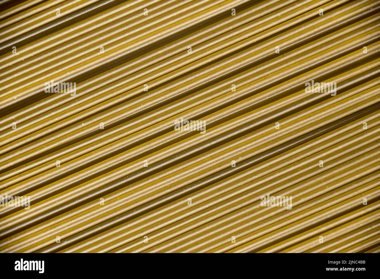 Italian healthy food background, raw spinach spaghetti filling the