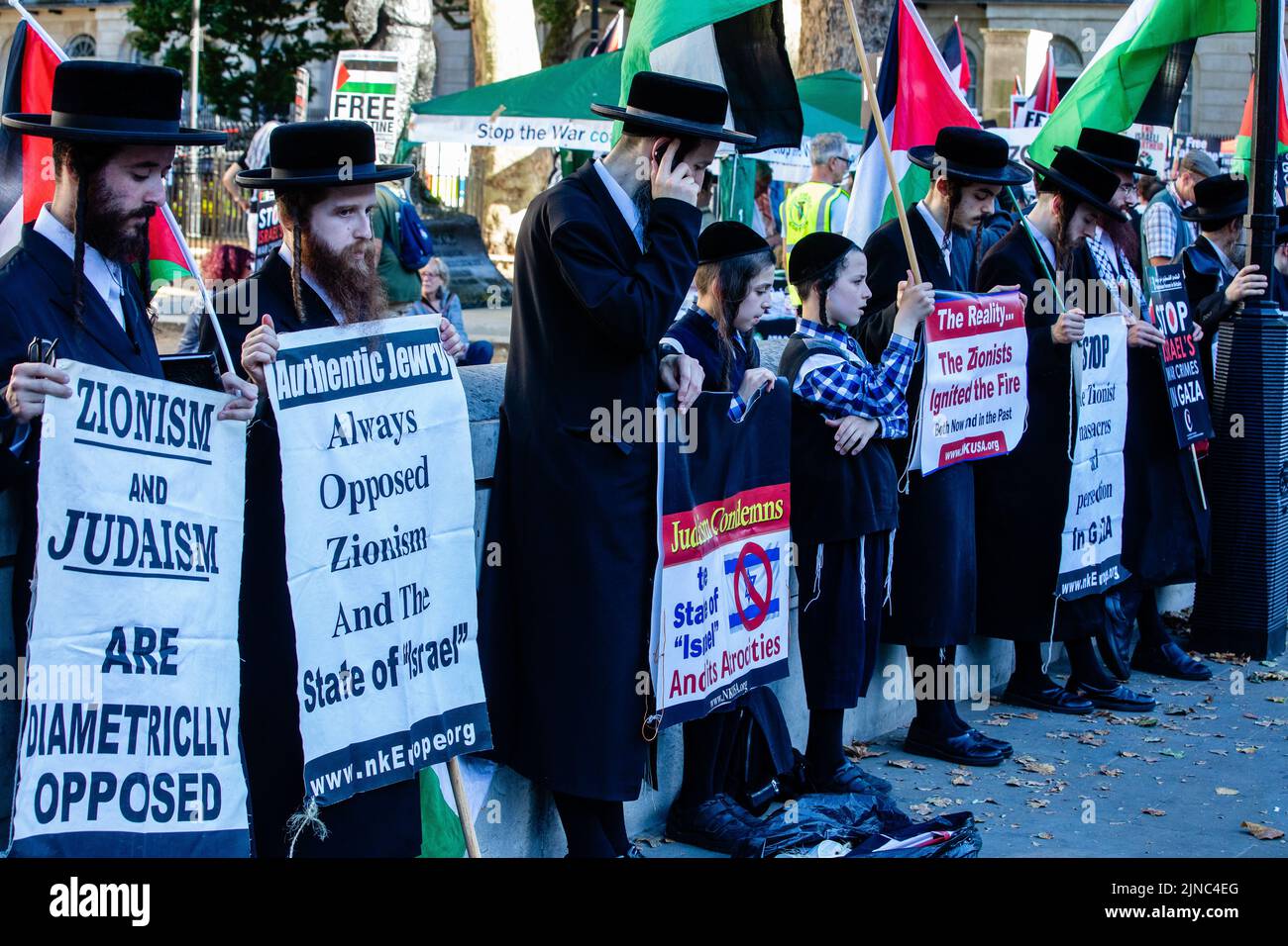 London, UK. 10th August 2022. Members of Neturei Karta, a group of ultra-Orthodox Jews which campaigns against Zionism, hold signs criticising the state of Israel at a Rally for Palestine opposite Downing Street. At least 47 Palestinians, including 16 children, were killed and hundreds more injured during a three-day bombardment of Gaza by Israeli forces named Operation Truthful Dawn. Credit: Mark Kerrison/Alamy Live News Stock Photo
