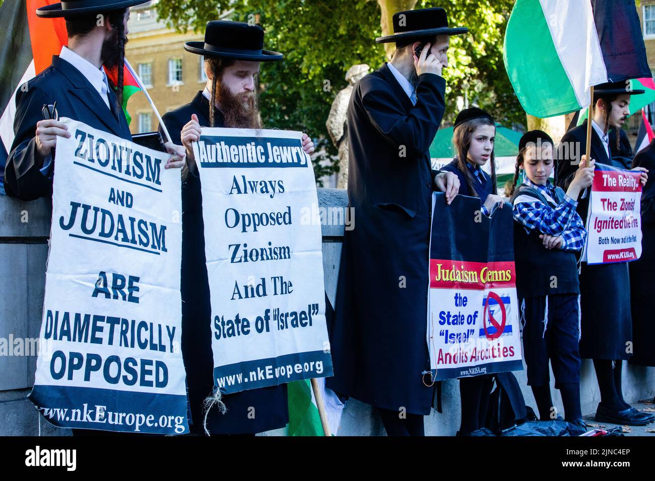 London, UK. 10th August 2022. Members of Neturei Karta, a group of ultra-Orthodox Jews which campaigns against Zionism, hold signs criticising the state of Israel at a Rally for Palestine opposite Downing Street. At least 47 Palestinians, including 16 children, were killed and hundreds more injured during a three-day bombardment of Gaza by Israeli forces named Operation Truthful Dawn. Credit: Mark Kerrison/Alamy Live News Stock Photo