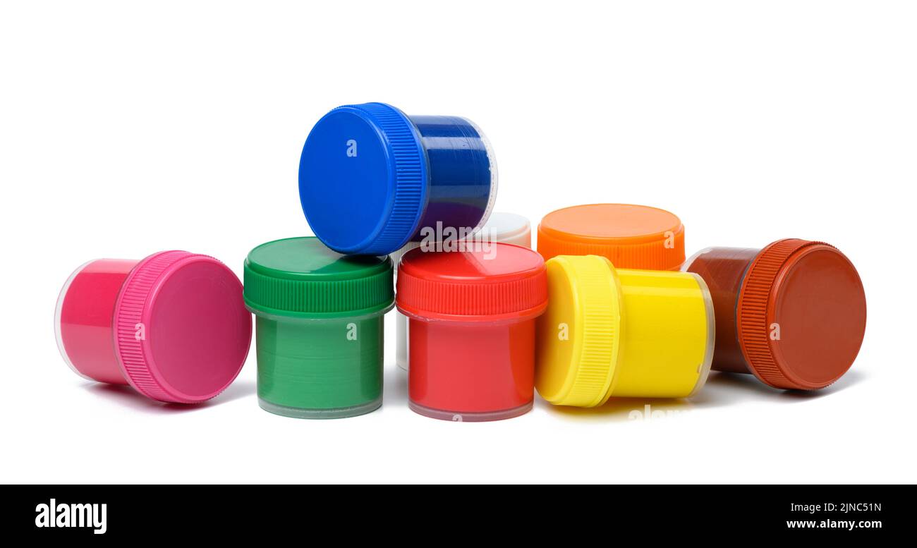 Plastic jars with multi-colored gouache on a white isolated background Stock Photo