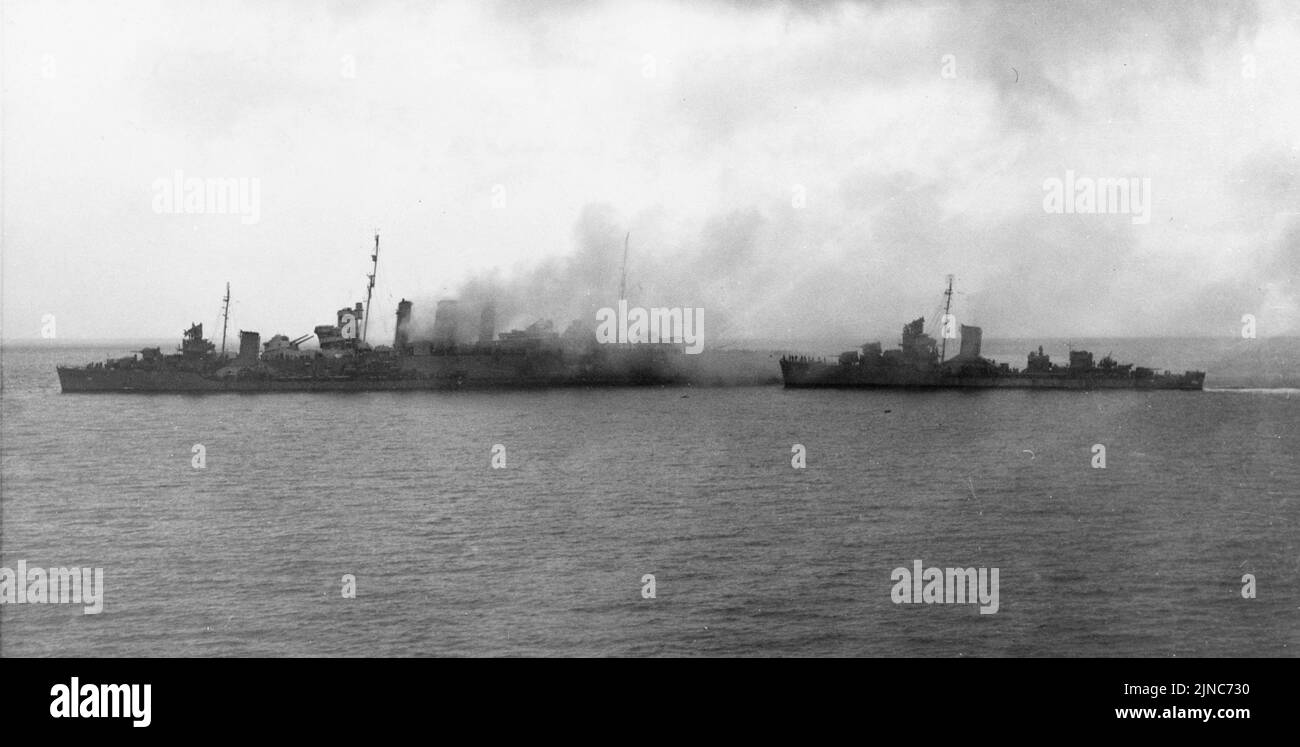 U.S. destroyers USS Blue and USS Patterson evacuate the crew from the burning HMAS Canberra. The Canberra was badly damaged in this action and was scuttled on the 9th August 1942 Stock Photo