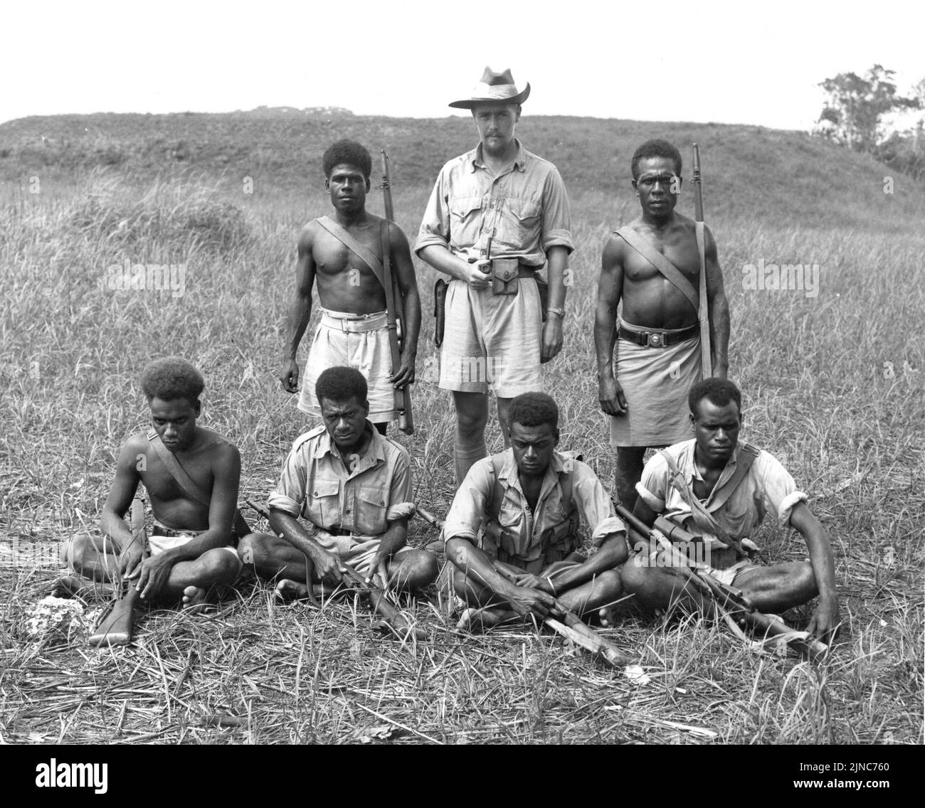 An Australian coastwatcher on Guadalcanal. The image shows Captain Martin Clemens and native members of the Solomon Islands police force. Stock Photo