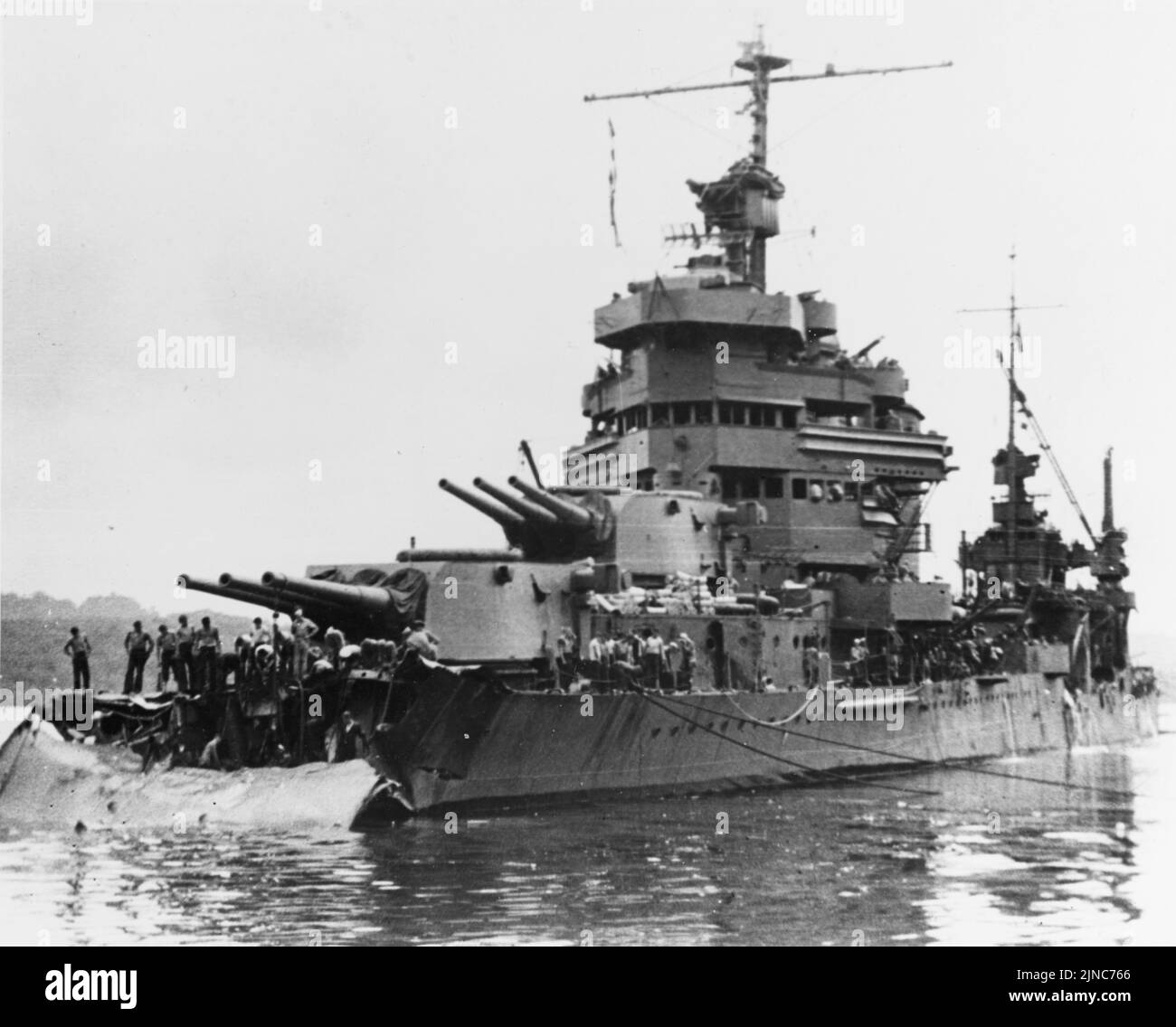 The U.S. Navy heavy cruiser USS Minneapolis (CA-36) at Tulagi with torpedo damage received in the Battle of Tassafaronga, the night before. The photograph was taken on 1 December 1942, as work began to cut away the wreckage of her bow. Stock Photo
