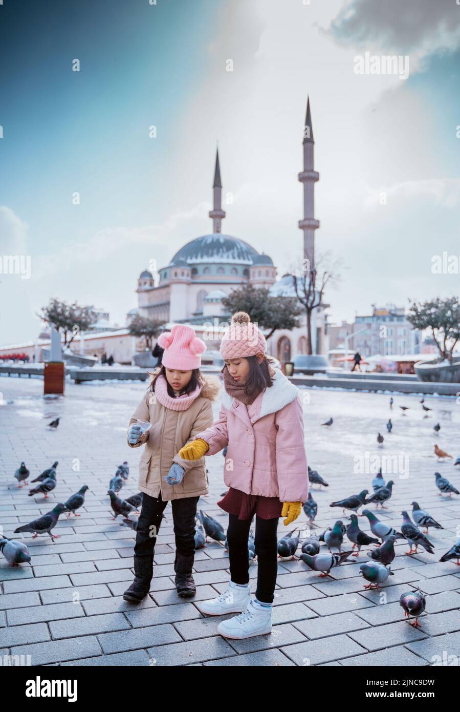 happy kids playing with pigeons in taksim square turkey Stock Photo - Alamy