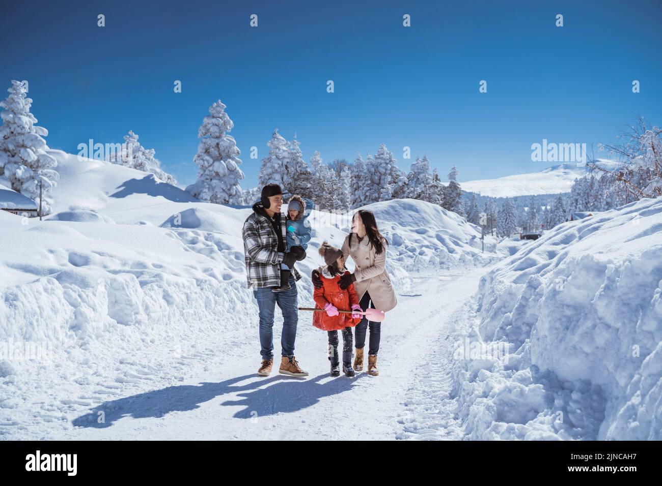 family walking together in winter with beautiful snow Stock Photo - Alamy