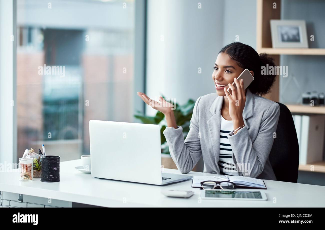 Business woman talking on phone call, networking and discussing a strategy while sitting at a desk alone at work. One happy corporate female Stock Photo