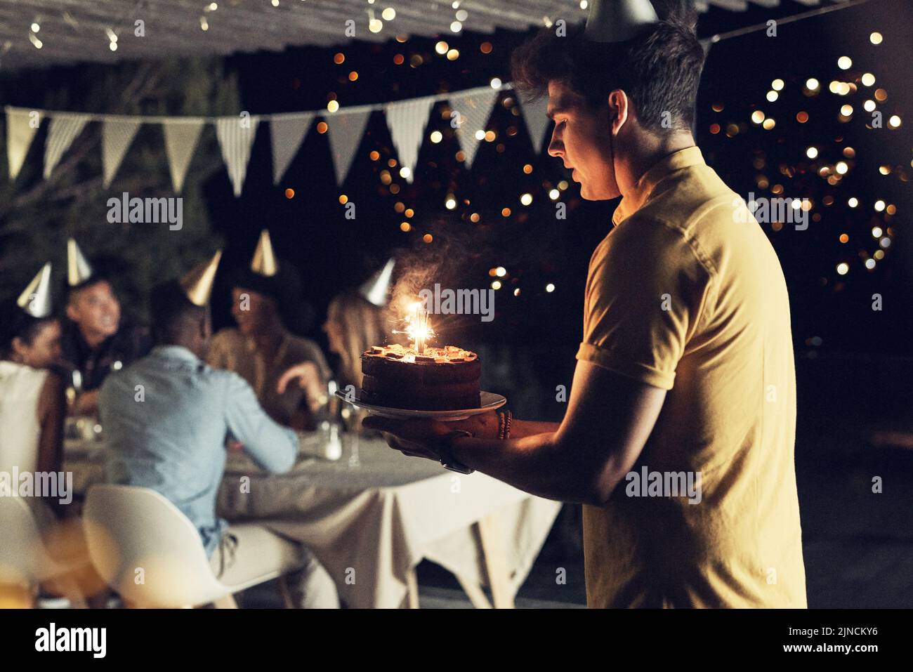 Trying my best to not drop the birthday cake. a handsome young man