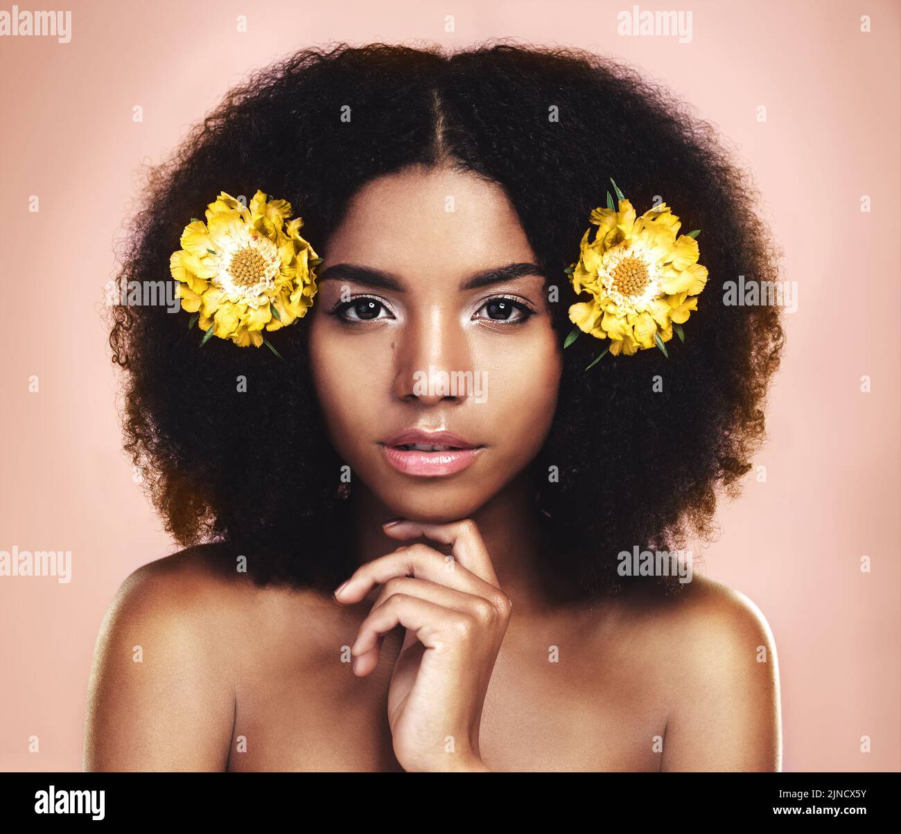 I can rule world with flowers in my hair. Studio shot of a beautiful