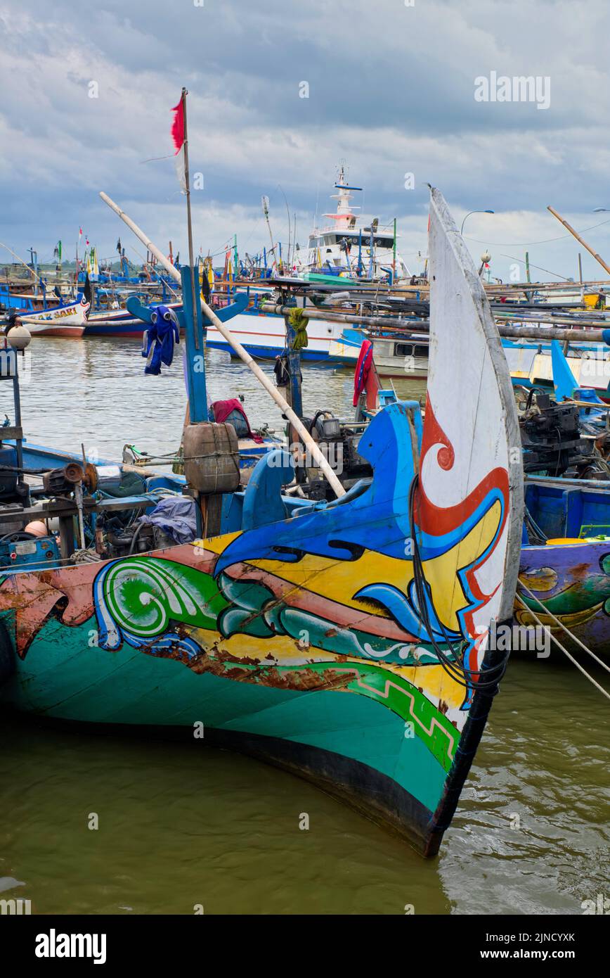 The fishing boats look beautiful with colorful pictures on the hull. The front of this fishing boat has almost the same motif and various colors typic Stock Photo