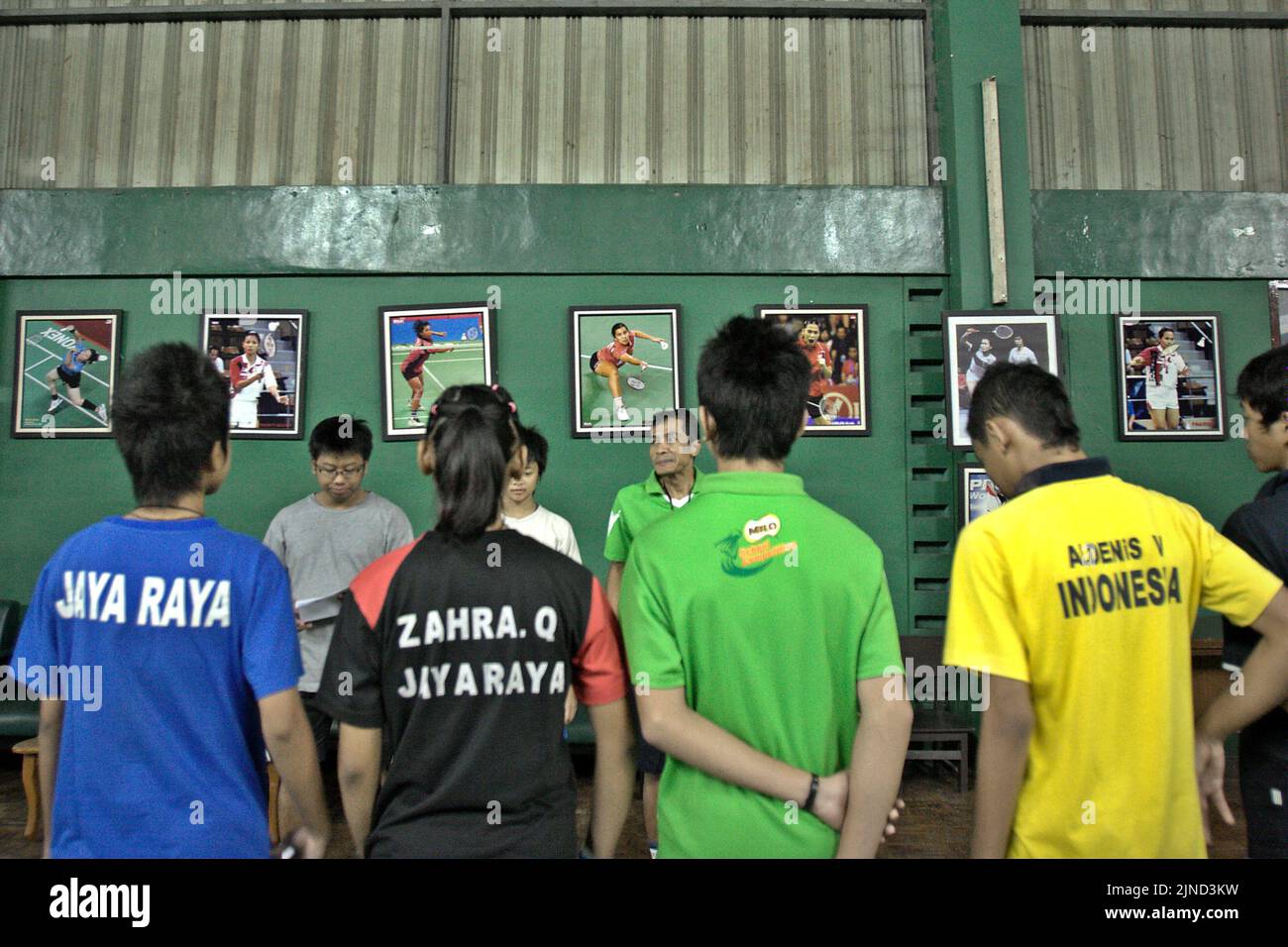 Young badminton players are given instructions during a training session at Jaya Raya badminton club in Jakarta, Indonesia. Stock Photo