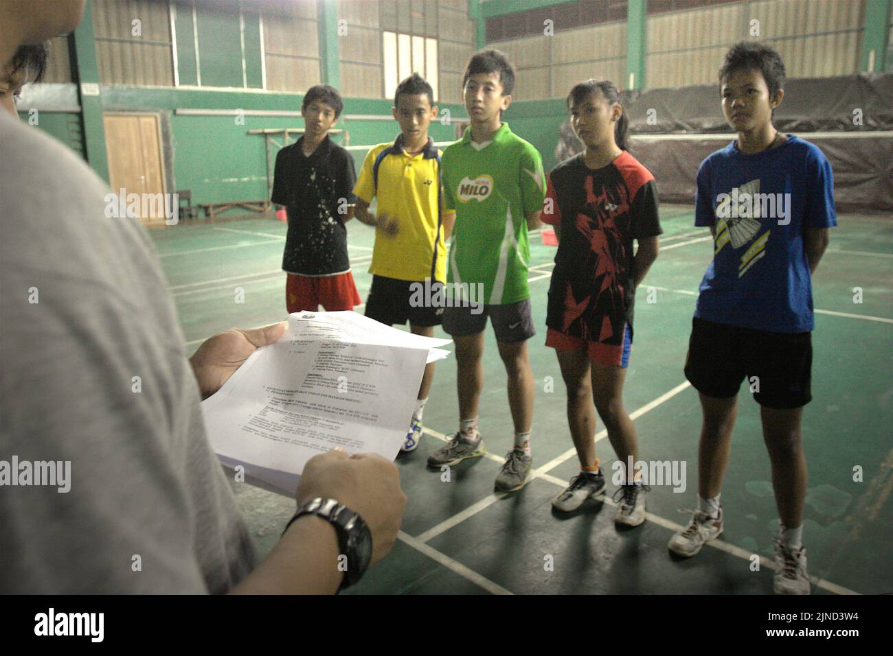 Young badminton players are given instructions during a training session at Jaya Raya badminton club in Jakarta, Indonesia. Stock Photo