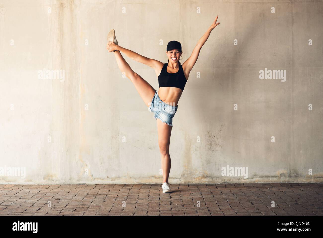 Shes beyond your stretch of imagination. an attractive young female street dancer practising out in the city. Stock Photo