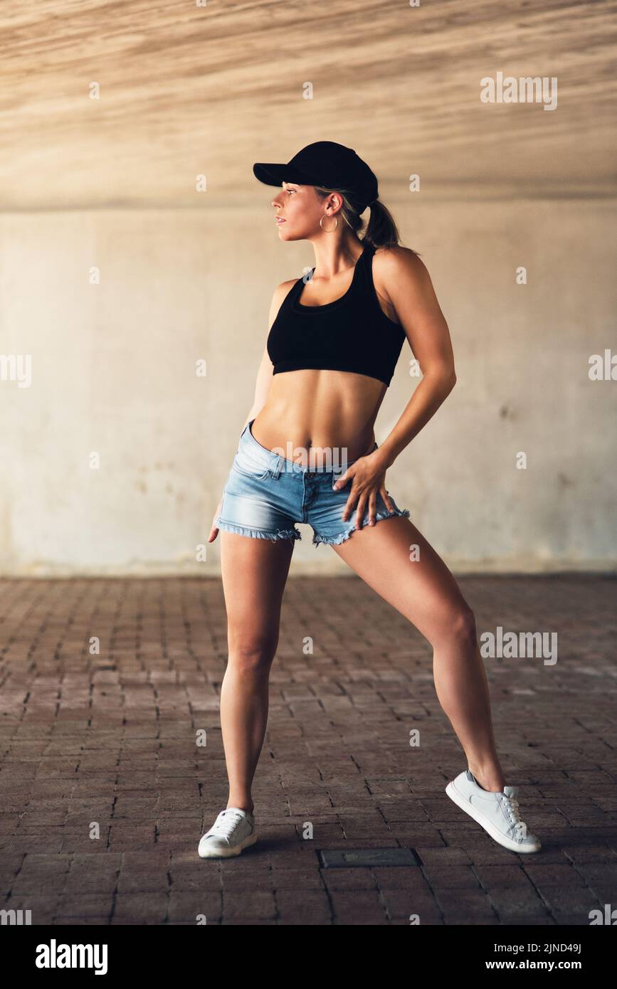 And thats how its done. Full length shot of an attractive young female street dancer practising out in the city. Stock Photo