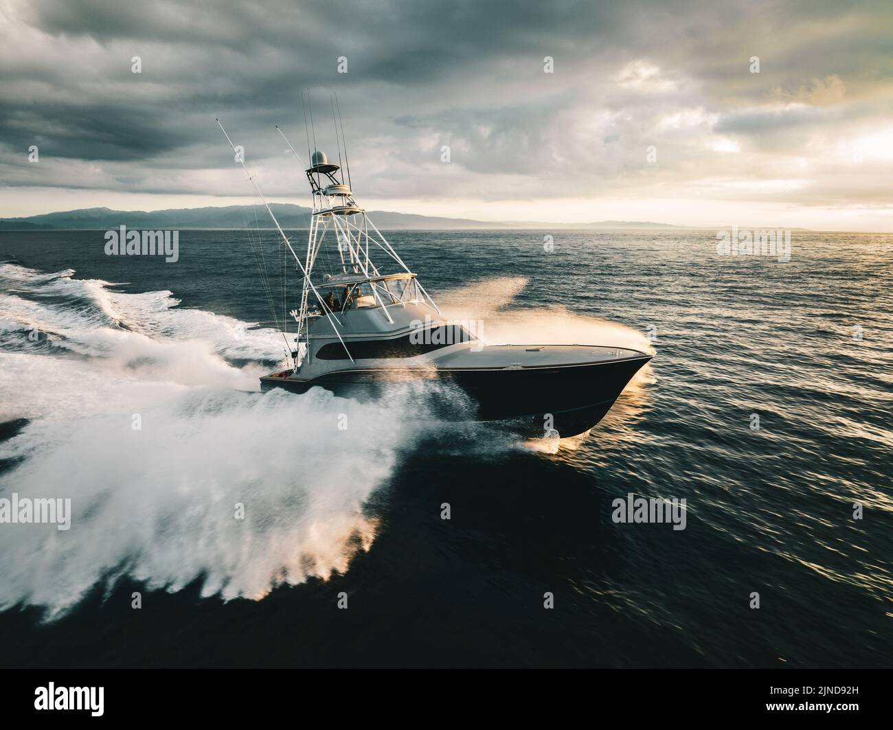 Fishing boat in the ocean crashing through waves Stock Photo Alamy