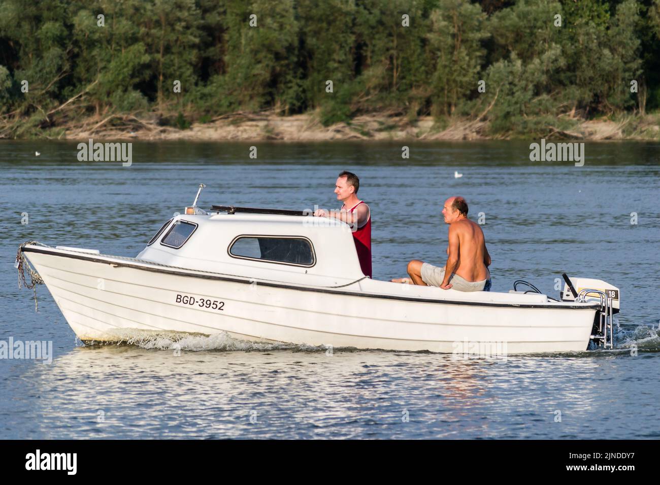 Novi Sad, Serbia - September 29. 2019: A panoramic view of the bank of the Danube river. A view of a small white boat with a cabin and passengers in t Stock Photo