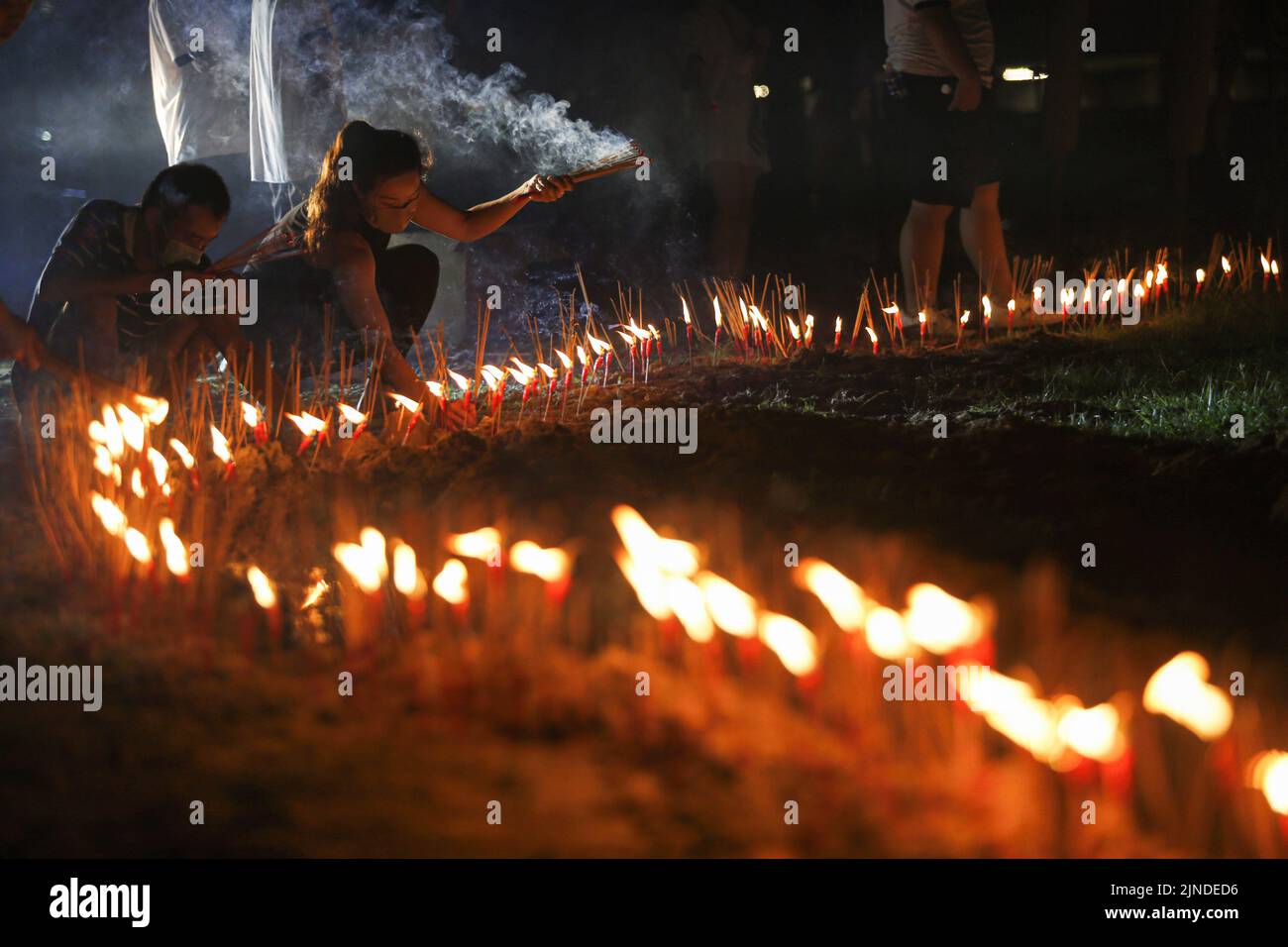 Kuala Lumpur, Malaysia. 01st Jan, 2000. Devotees burn candles and joss