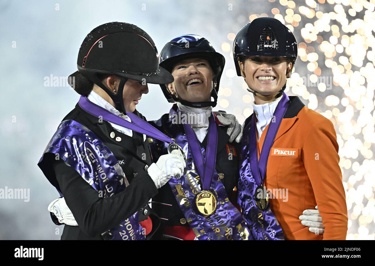 Herning, Denmark. 10th Aug, 2022. World Equestrian Games. Stables. The 3 medalists. (l to r) Catherine Laudrop-Dufour (DEN, silver), Charlotte Fry (GBR, Gold) and Dinja van Liere (NED, bronze) share a joke during the Individual Dressage Grand Prix Freestyle medal ceremony. Credit: Sport In Pictures/Alamy Live News Stock Photo