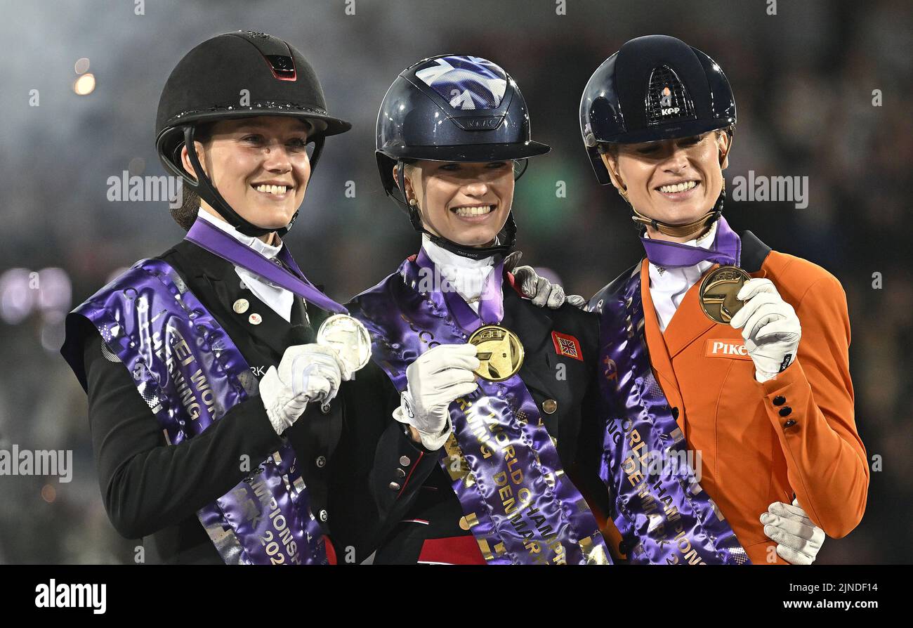 Herning, Denmark. 10th Aug, 2022. World Equestrian Games. Stables. The 3 medalists. (l to r) Catherine Laudrop-Dufour (DEN, silver), Charlotte Fry (GBR, Gold) and Dinja van Liere (NED, bronze) share a joke during the Individual Dressage Grand Prix Freestyle medal ceremony. Credit: Sport In Pictures/Alamy Live News Stock Photo
