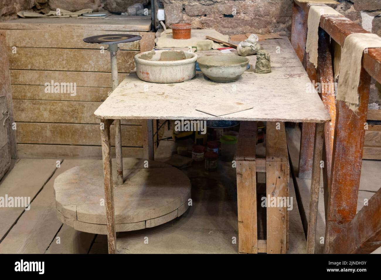 Potter's A working table with clay and a potter's wheel Stock Photo Alamy