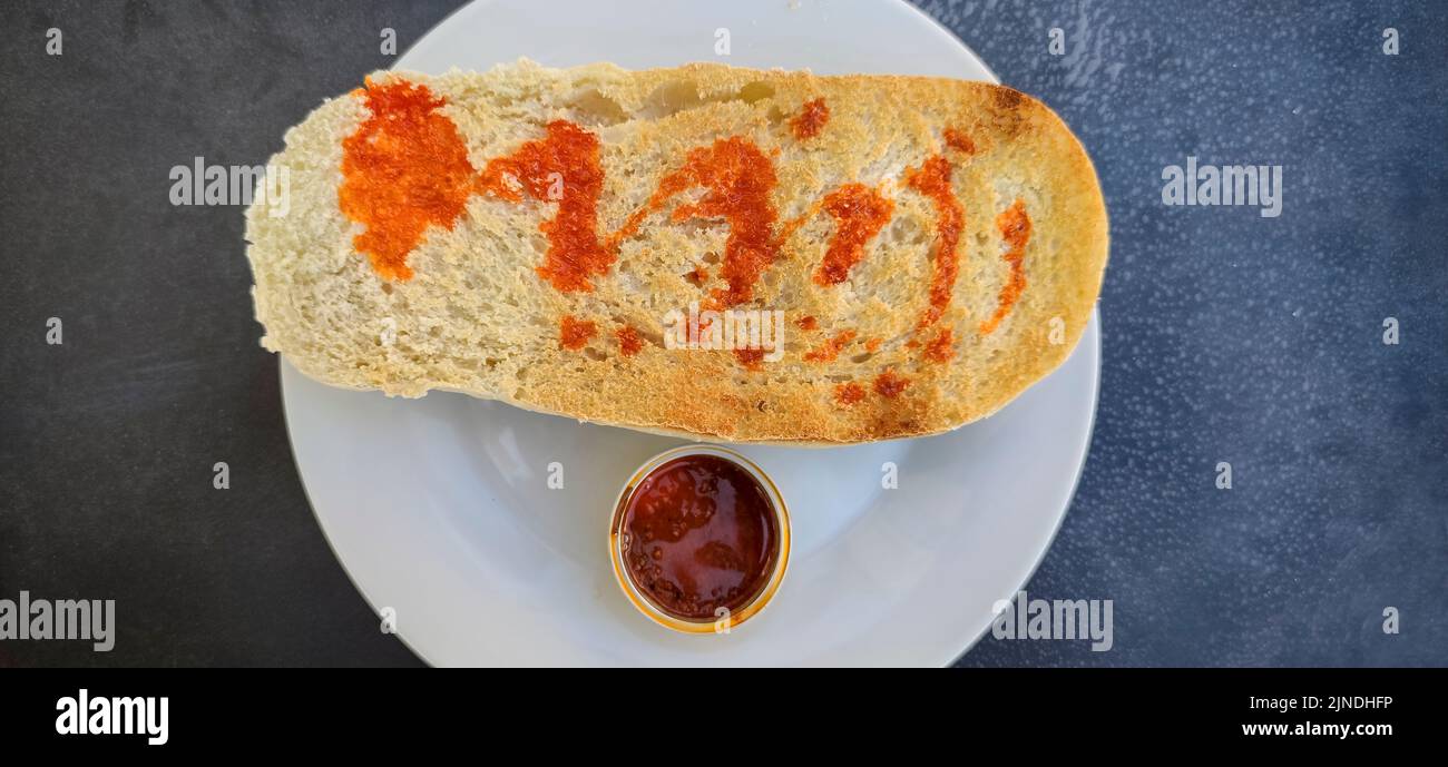 Iberian cachuela bread toast. Single-serve cachuela container Stock Photo