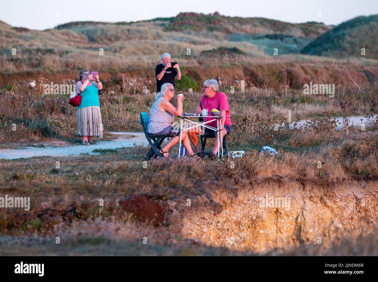 People photograph the Sunset in Godrevy, Cornwall,UK Stock Photo