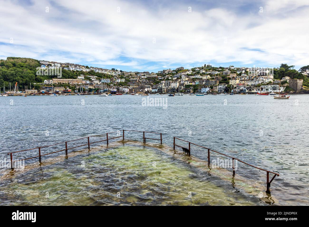 View to Polruan across the River Fowey in Cornwall, with the old Whitehouse sea pool in the foreground. Stock Photo