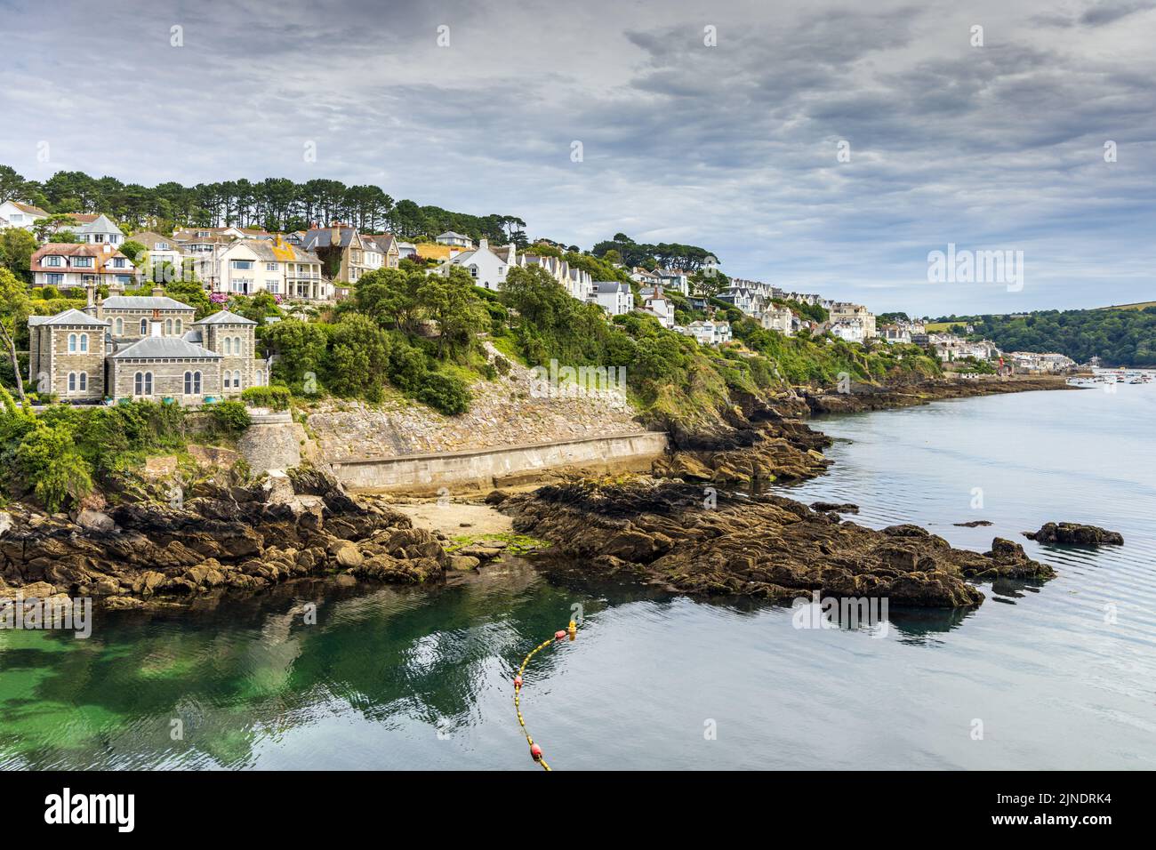 View up the River Fowey towards the town of Fowey in Cornwall. The large house on the left is Point Neptune House, recently owned by Dawn French. Stock Photo