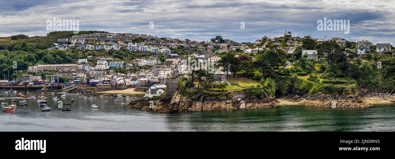 Panorama format of the attractive fishing village of Polruan in Cornwall. Polruan has a history of ship-building and it still has a boatyard. Stock Photo