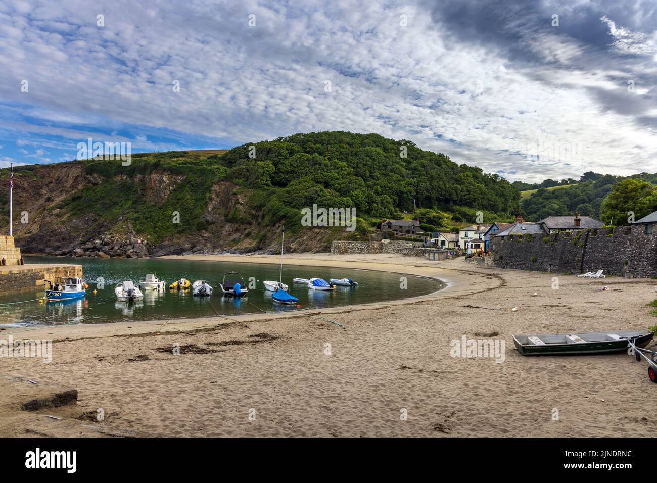 Pleasure boats berthed at Polkerris in Cornwall, a delightful sandy cove with a small harbour. Stock Photo