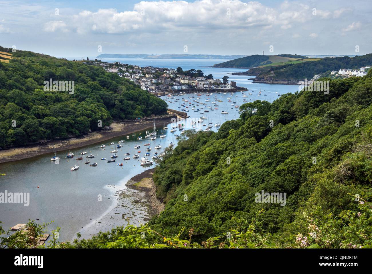 Elevated view of the Fowey estuary and the coastal village of Polruan and its harbour in Cornwall. Pont Pill provides a natural harbour for boats. Stock Photo