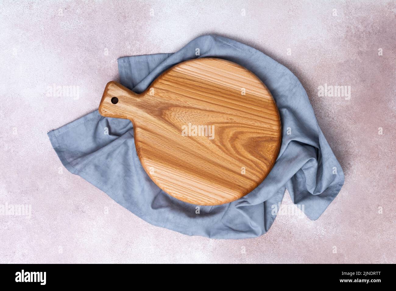 Wooden cutting board on a light background. Kitchenware top view. Empty space for your ready meals. Stock Photo