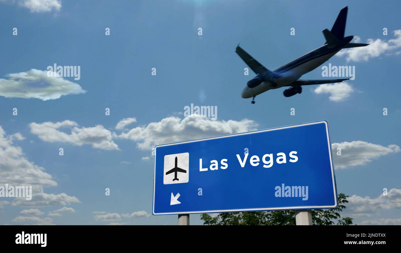 Airplane silhouette landing in Las Vegas, Nevada, USA. City arrival with international airport direction signboard and blue sky. Travel, trip and tran Stock Photo