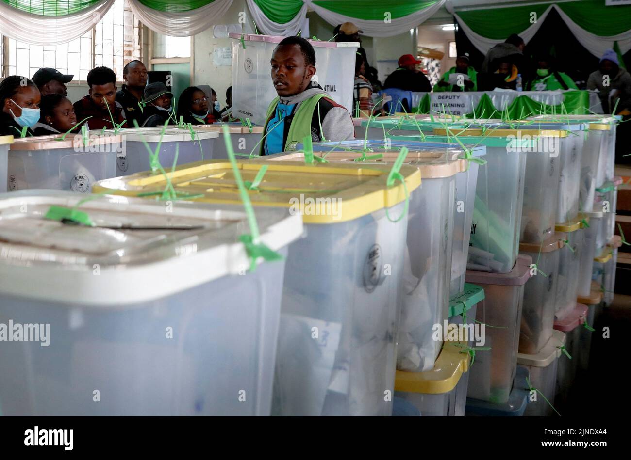 A memeber of polling staff walks among sealed ballot boxes containing electoral materials at an Independent Electoral and Boundaries Commission (IEBC) tallying centre after the general election in Nairobi, Kenya August 11, 2022. REUTERS/Thomas Mukoya Stock Photo