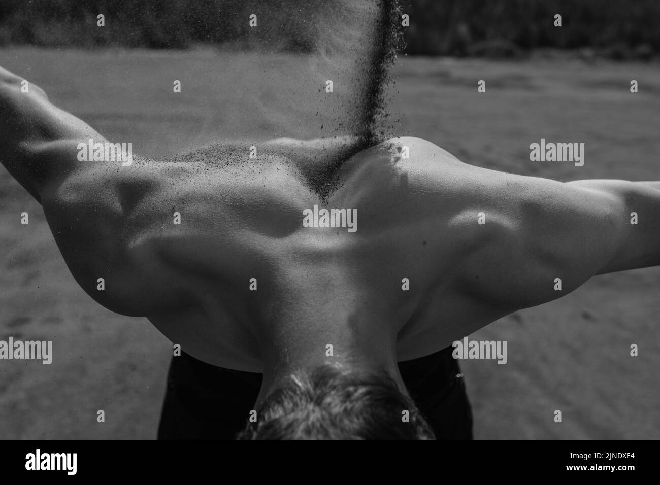 sand falls on the man's back Stock Photo