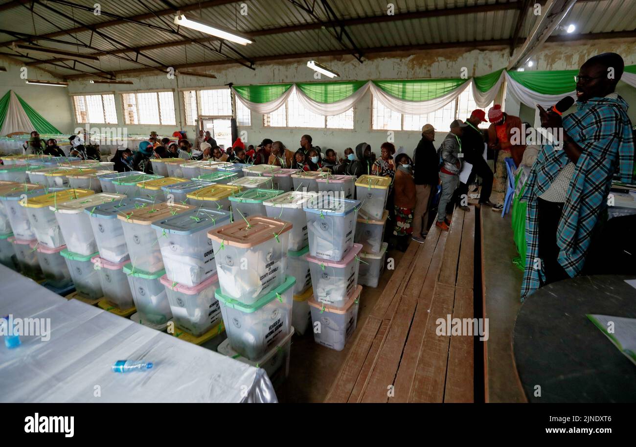 A general view shows polling agents and sealed ballot boxes containing electoral materials at an Independent Electoral and Boundaries Commission (IEBC) tallying centre after the general election in Nairobi, Kenya August 11, 2022. REUTERS/Thomas Mukoya Stock Photo