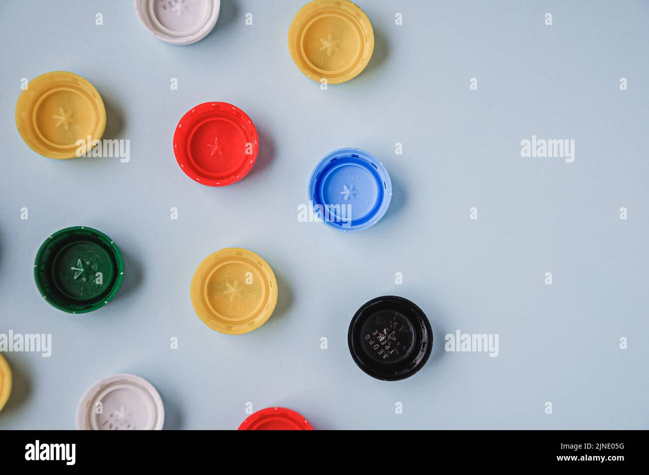 Plastic bottle caps background. Cap material is recyclable. Recycling