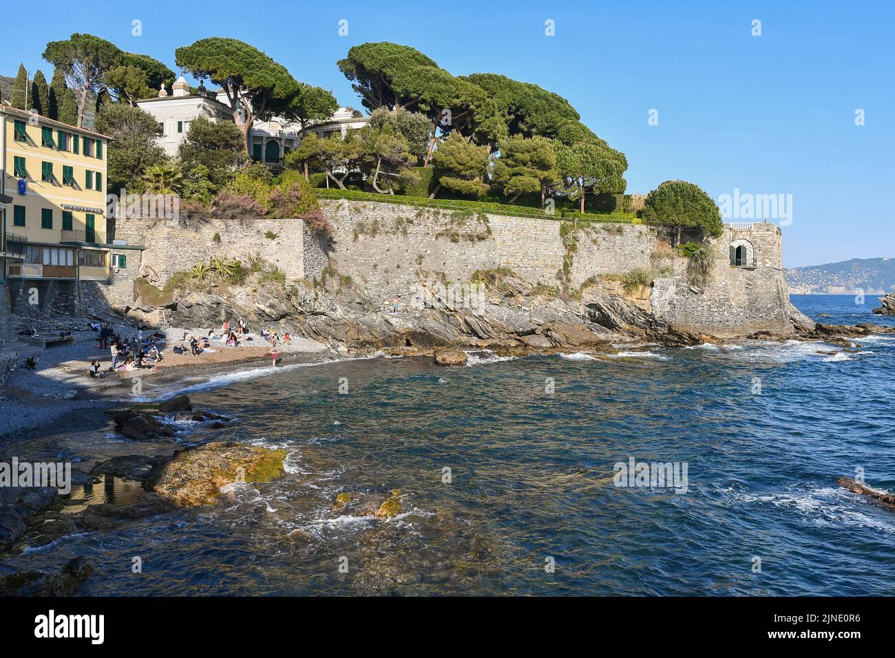 View of the small beach of Capolungo, neighborhood by the sea where the Anita Garibaldi Promenade ends, with holiday villas on the cliff, Nervi, Genoa Stock Photo