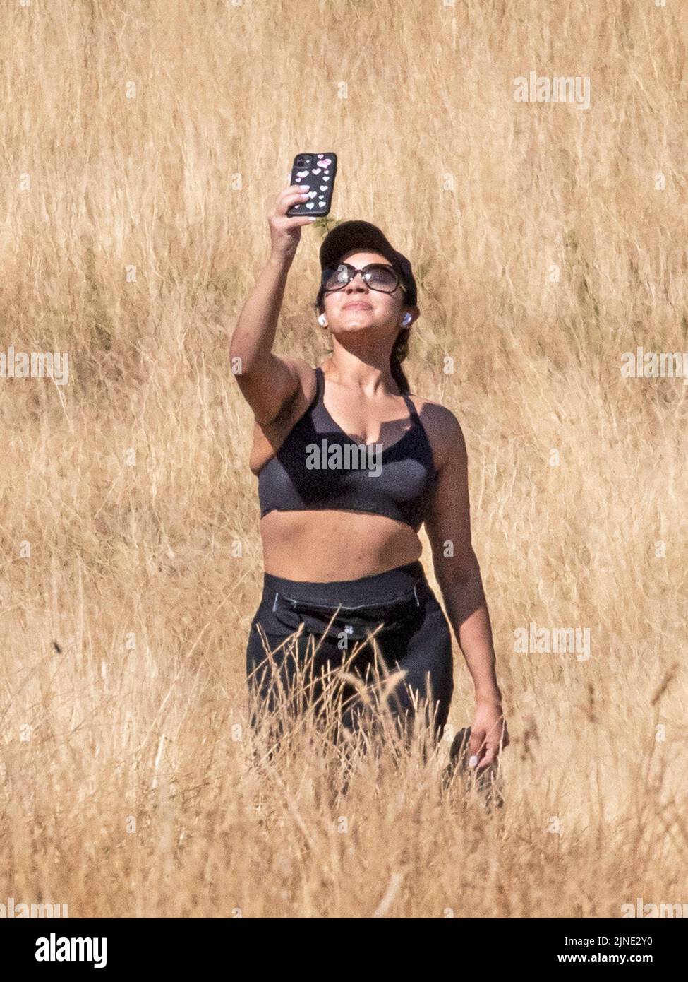 London ,United Kingdom  -09/08/2022. A woman takes a selfie on a dried out Hampstead Heath, North London as the UK heads into another period of hot an Stock Photo