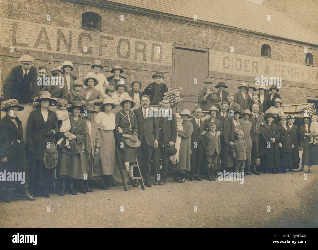 Historical Archive Image of workers outside the Langford Cider & Perry Factory in Hereford, England, c1920s. Ready for a factory outing. Stock Photo