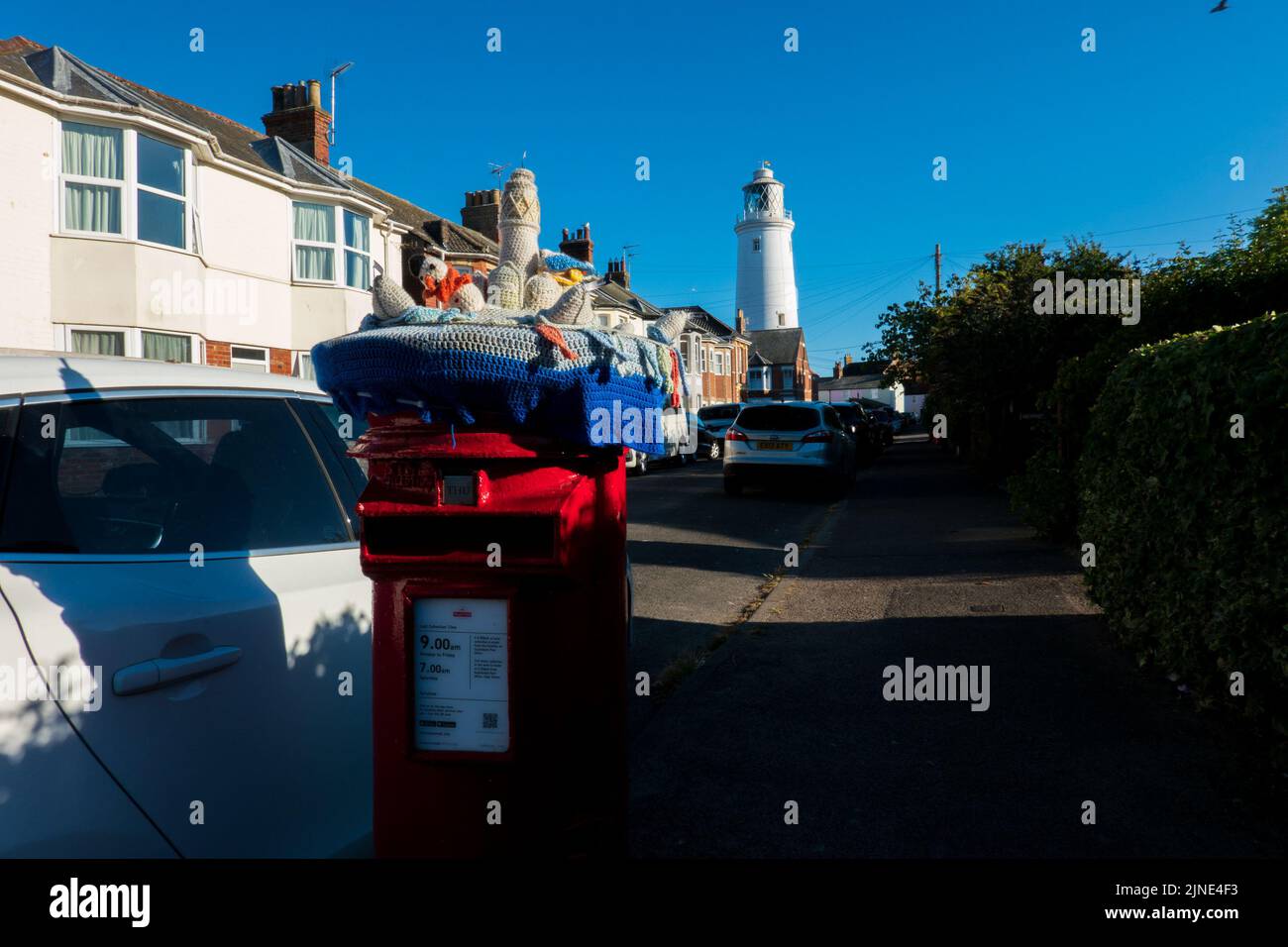 Southwold red post boxes decorated with knitted scenes Stock Photo