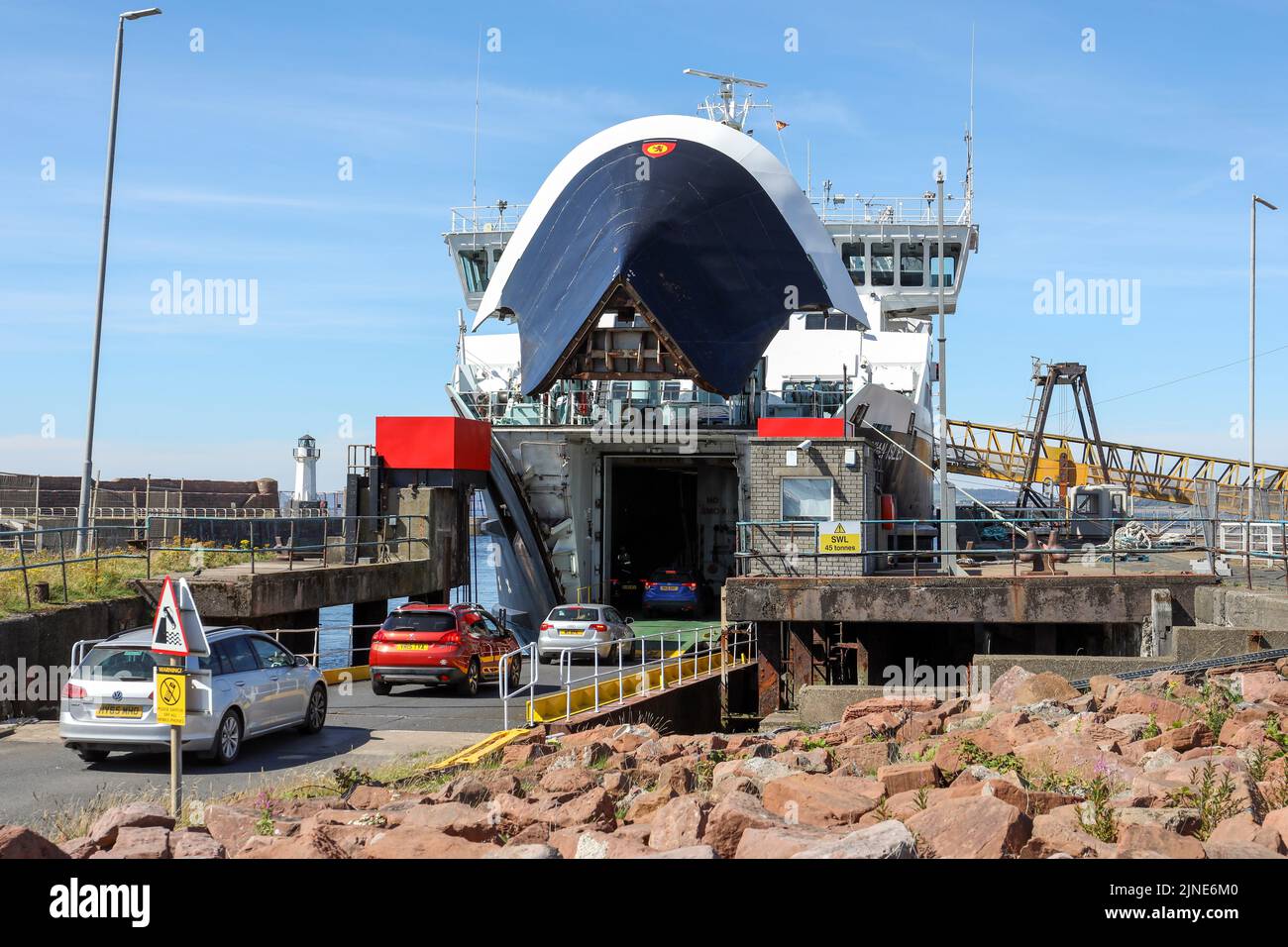 Caledonian MacBrayne ferry, Caledonian Isles, sailing from Isle of Arran, across the Firth of Clyde, berthed at Ardrossan and vehicles boarding via th Stock Photo