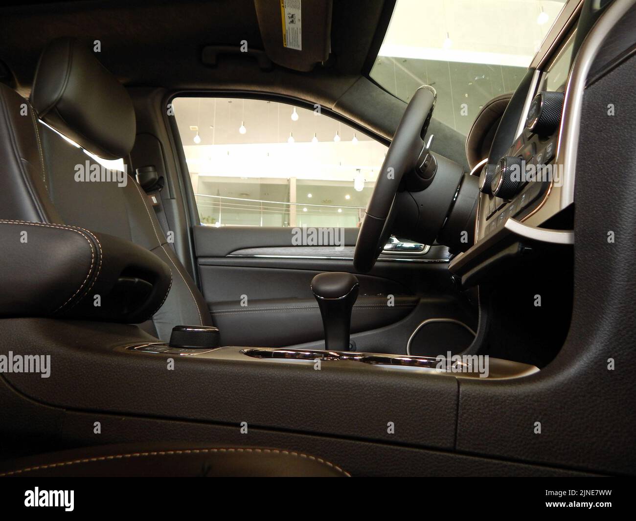 Side view of drivers seat, steering wheel and gear shift knob inside