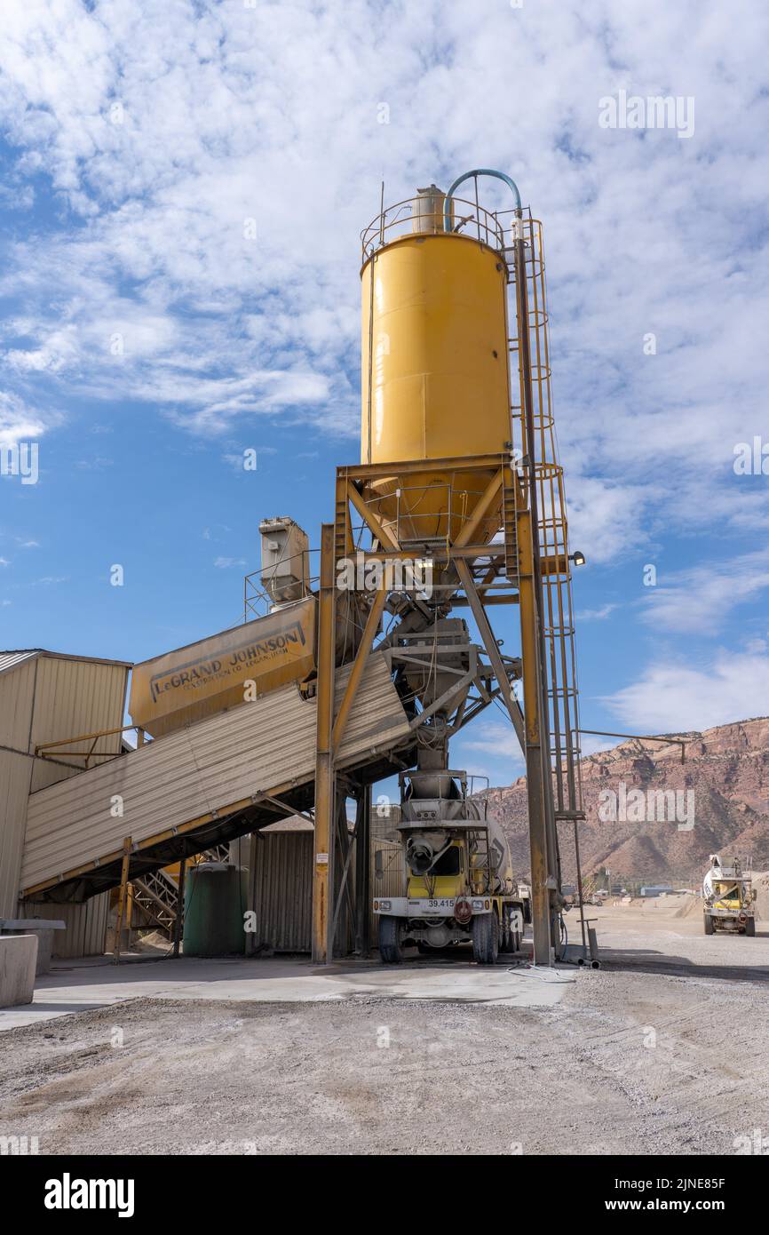 A cement truck fills with concrete at a concrete batch plant near Moab
