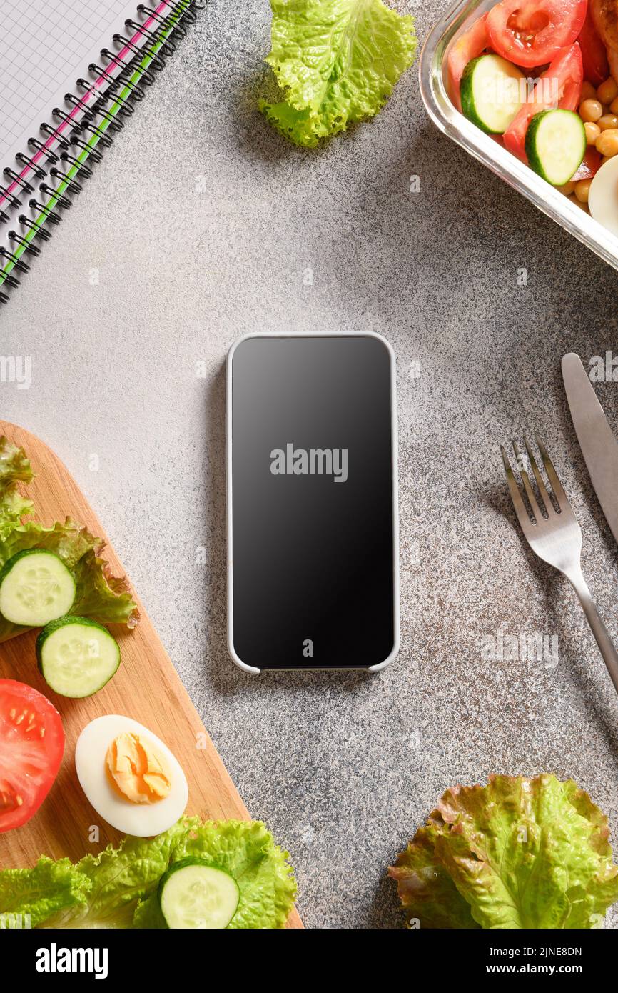 https://c8.alamy.com/comp/2JNE8DN/weight-loss-concept-calories-counting-diet-food-control-and-calorie-counter-application-on-smartphone-with-salad-egg-and-vegetable-2JNE8DN.jpg