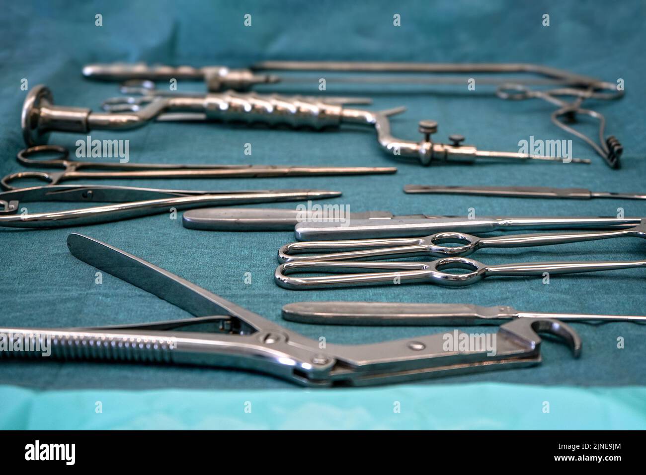 Set of steel surgical tools on blue cloth - real instruments used in mobile medical army tent Stock Photo