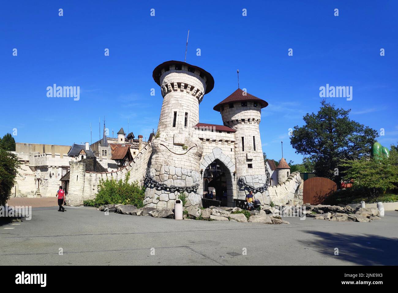 Plailly, France - August 10 2022: The Smiling castle towers making the entrance of the 'À travers le temps' zone inside the Parc Astérix, a theme park Stock Photo