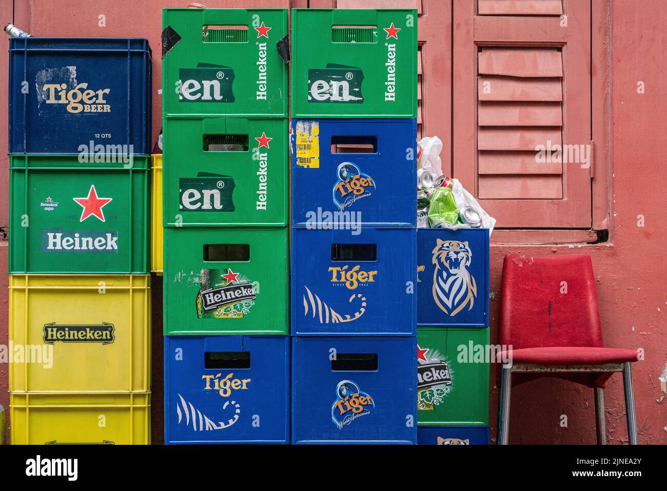 Empty beer crates are stacked neatly outside a bar in Boat Quay, Singapore. Horizontal Shot. Stock Photo