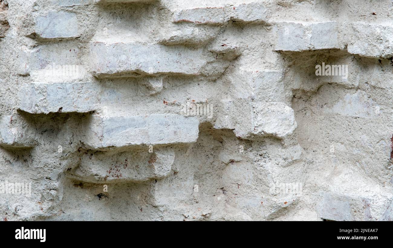 A brick wall painted with white primer is the wall of an old manor house Stock Photo