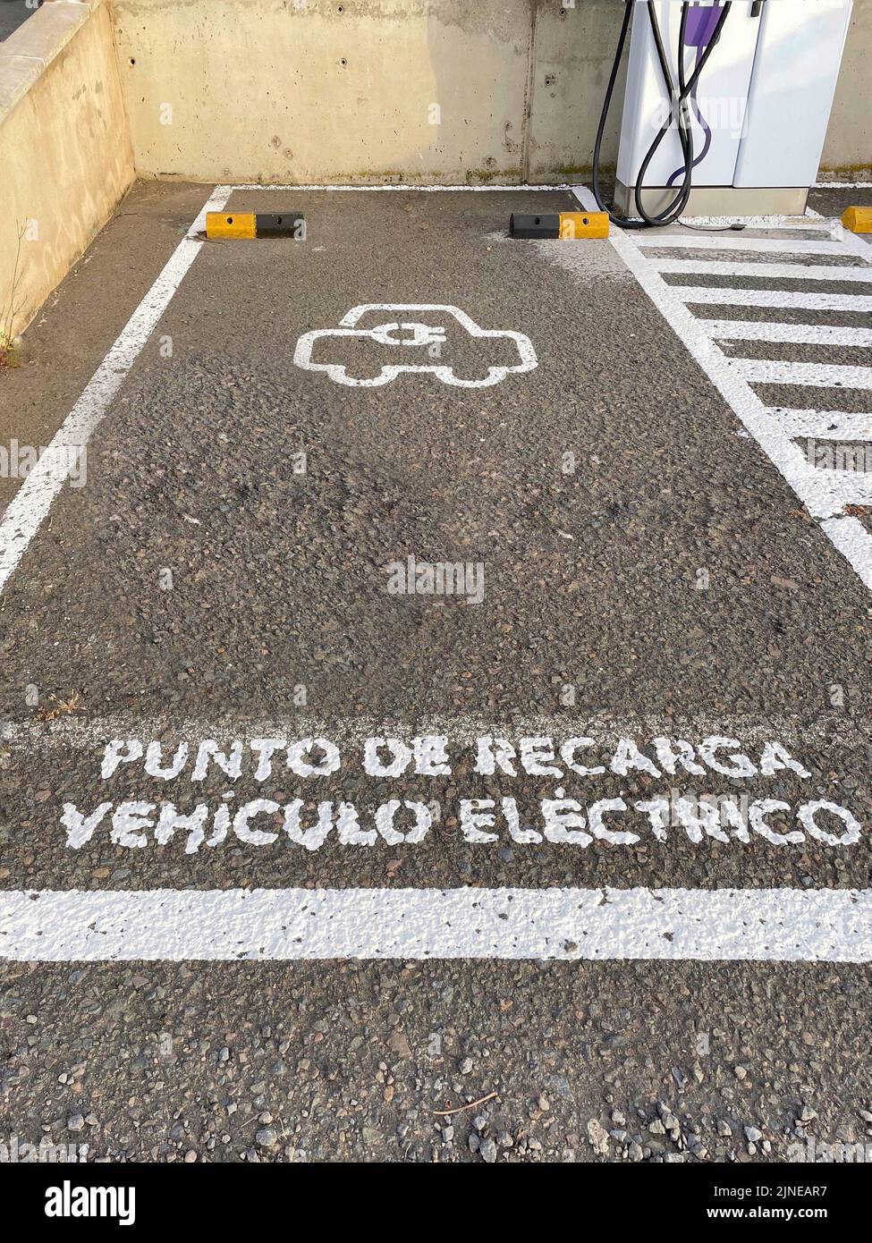A high angle shot of a sign of an "electric vehicle charging point" in
